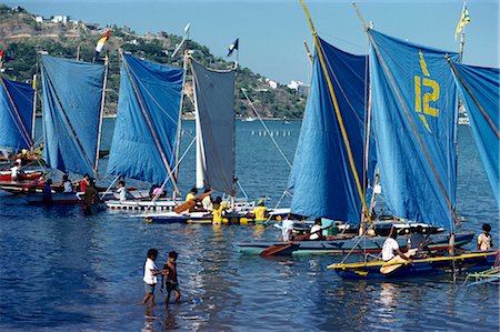sailboat racing - Boats with blue sails line up at the start of a Lakatoi canoe race, Konedobu, Port Moresby, Papua New Guinea, Pacific Islands, Pacific Stock Photo - Rights-Managed, Code: 841-02711906
