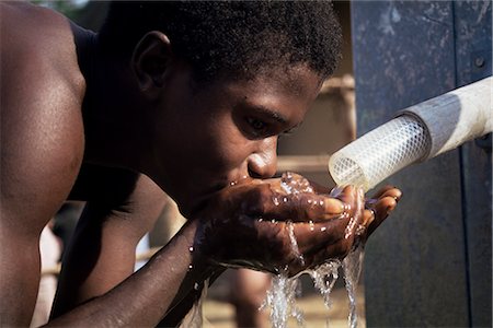 Teenage boy drinking from new UNICEF well, Vahun, Liberia, West Africa, Africa Stock Photo - Rights-Managed, Code: 841-02712170