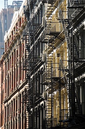 Fire escapes on the outside of buildings in Spring Street, Soho, Manhattan, New York City, New York, United States of America, North America Stock Photo - Rights-Managed, Code: 841-02712555