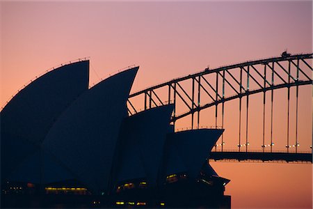 Sydney Opera House and Harbour Bridge silhouetted together at sunset, Sydney, New South Wales, Australia Stock Photo - Rights-Managed, Code: 841-02713011