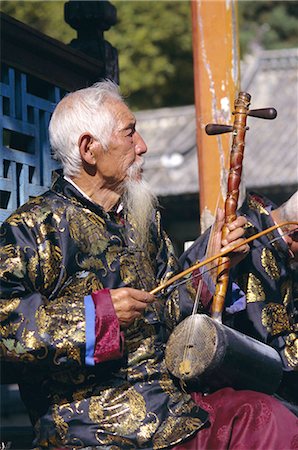 Portrait of an elderly musician from the Naxi orchestra practising by the Black Dragon Pool, Lijiang, Yunnan Province, China, Asia Stock Photo - Rights-Managed, Code: 841-02713079