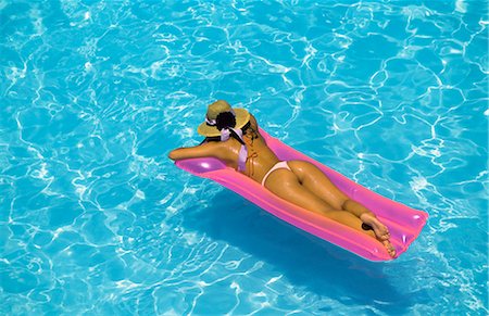 pool inflatable mattresses - Woman in swimming pool Stock Photo - Rights-Managed, Code: 841-02722535