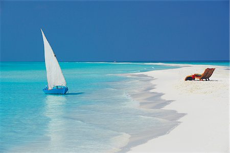 Traditional dhoni and lounge chairs on beach, Maldives, Indian Ocean, Asia Stock Photo - Rights-Managed, Code: 841-02722537