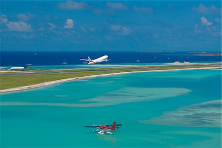Passenger jet taking off from Male International Airport, and Maldivian air taxi ready to take off, Maldives, Indian Ocean, Asia Stock Photo - Rights-Managed, Code: 841-02722533