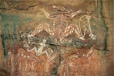 Namondjok in centre, who ate his clan sister, Namarrgon on right the Lightning Man and Barrginj his wife below left, supernatural ancestors at the rock art site, Nourlangie Rock, Kakadu National Park, UNESCO World Heritage site, Northern Territory, Australia, Pacific Stock Photo - Rights-Managed, Code: 841-02722974