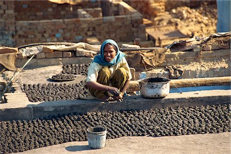 pooping - Woman making dung pats for fuel, Agra, Uttar Pradesh state, India, Asia Stock Photo - Rights-Managed, Code: 841-02826111