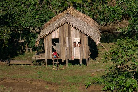 single storey - People waving from their thatched palm house on the waters edge, Caboclos, in the Breves Narrows in the Amazon area of Brazil, South America Stock Photo - Rights-Managed, Code: 841-02831155