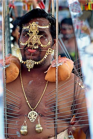 Portrait of a man with pierced tongue and spikes in his skin during the Kavadis procession in Thaipusam festival of purification in Singapore, Southeast Asia, Asia Stock Photo - Rights-Managed, Code: 841-02832856