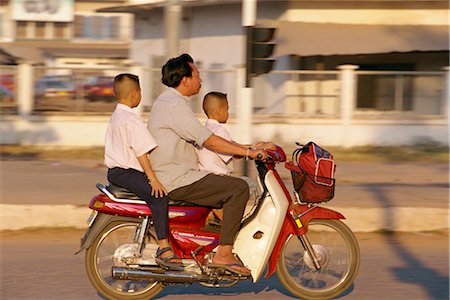 simsearch:841-02831527,k - Father and two sons on a motorcycle in the downtown area of Vientiane city, Laos, Indochina, Southeast Asia, Asia Stock Photo - Rights-Managed, Code: 841-02899097