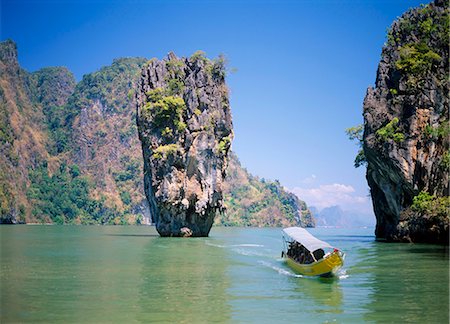 phang nga bay - Petit bateau s'approcher de la plage à Ko Tapu (James Bond Island), baie de Phang Nga, Thaïlande Photographie de stock - Rights-Managed, Code: 841-02899471