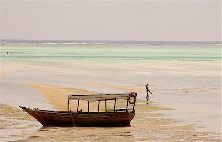 An old wooden boat in the sea at low tide, Paje, Zanzibar, Tanzania, East Africa, Africa Stock Photo - Rights-Managed, Code: 841-02899904