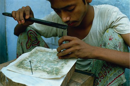 stencils - Tapping out the block print design through a stencil, from which the carver will work, India, Asia Stock Photo - Rights-Managed, Code: 841-02900219