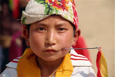 Portrait of a Tibetan boy with needle inserted in his cheek, during Harvest Festival, Coming of Age, in Qinghai, China, Asia Stock Photo - Rights-Managed, Code: 841-02901229