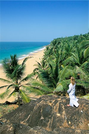 Woman looking over coconut palms to the beach, Kovalam, Kerala state, India, Asia Stock Photo - Rights-Managed, Code: 841-02903039