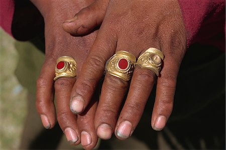 Gold rings with red coral stones worn by Thakuri peasant woman, Simikot, Nepal, Asia Stock Photo - Rights-Managed, Code: 841-02915605