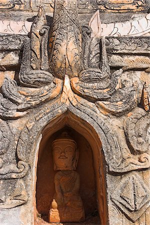 Antique Buddha image in niche below stupa, Kakku Buddhist Ruins, said to contain over two thousand brick and laterite stupas, legend holds that the first stupas were erected in the 12th century by Alaungsithu, King of Bagan (Pagan), Shan State, Myanmar (Burma), Asia Stock Photo - Rights-Managed, Code: 841-02916581