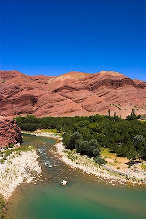 Hari Rud river flows through fertile valley at base of red rock mountains, between Jam and Chist-I-Sharif, Ghor (Ghowr) province, Afghanistan, Asia Stock Photo - Rights-Managed, Code: 841-02916865