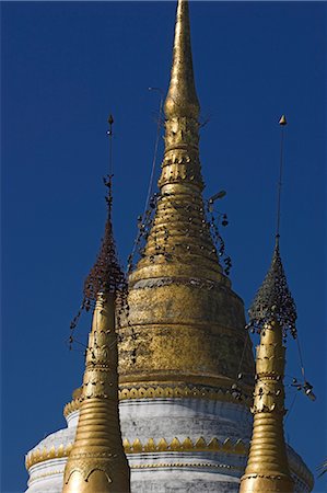 Gilded zedi, said to contain Buddha's hair relics, topped by gold hti inlaid with silver, rubies, diamonds, sapphires and jade, hung with tiny gold bells, Wat Jong Kham, founded in the 13th century, Kengtung (Kyaing Tong), Shan state, Myanmar (Burma), Asia Stock Photo - Rights-Managed, Code: 841-02917021