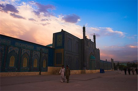 People walk at sunset past the Shrine of Hazrat Ali, who was assassinated in 661, Mazar-i-Sharif, Afghanistan, Asia Stock Photo - Rights-Managed, Code: 841-02917197