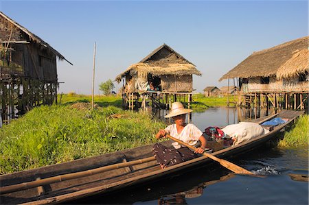 Woman in canoe paddles past floating village, Inle Lake, Shan State, Myanmar (Burma), Asia Stock Photo - Rights-Managed, Code: 841-02917357