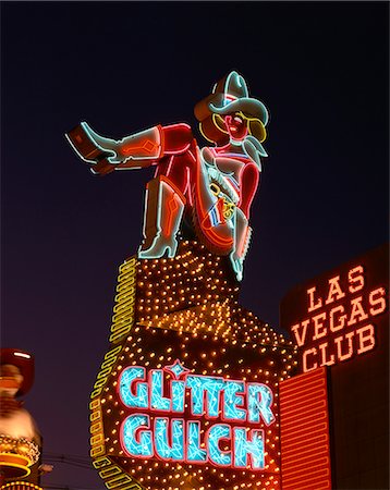 Close-up of neon sign of a cowgirl advertising Glitter Gulch at night in Las Vegas, Nevada, United States of America, North America Foto de stock - Con derechos protegidos, Código: 841-02918309