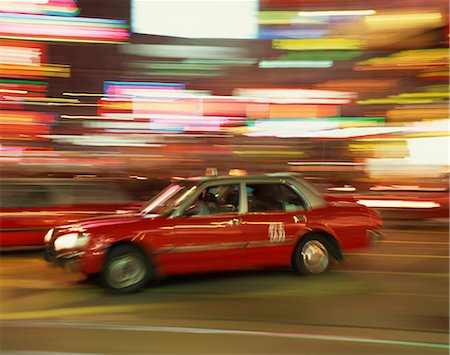 Red taxi driving at speed at night in Causeway Bay, Hong Kong, China, Asia Stock Photo - Rights-Managed, Code: 841-02918426