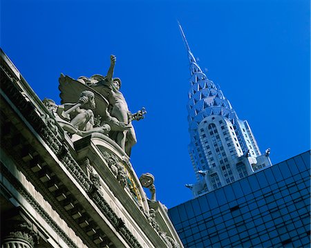 Close-up of statues on top of Grand Central Station, with the Chrysler Building in the background, taken in the evening in New York, United States of America, North America Stock Photo - Rights-Managed, Code: 841-02918466