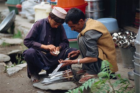 simsearch:841-02824447,k - Un jeune homme compter son argent acheter un couteau de rue négociant à Gilgit, Pakistan, Asie Photographie de stock - Rights-Managed, Code: 841-02918588