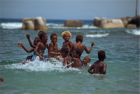 Boys playing in the sea, Lenakel, Tanna, Vanuatu, Pacific Islands, Pacific Fotografie stock - Rights-Managed, Codice: 841-02925521