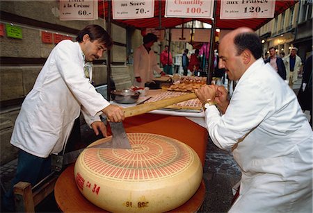 Two foot diameter Gruyere cheese being cut to size in market, Luxembourg City, Luxembourg, Europe Stock Photo - Rights-Managed, Code: 841-02925601