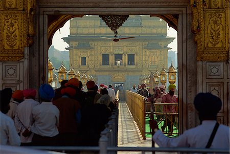 Sikhs at the entrance to the Golden Temple, crossing Guru's Bridge travelling in a clockwise direction, in Amritsar, Punjab, India, Asia Stock Photo - Rights-Managed, Code: 841-02920102