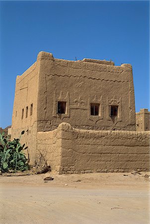 Mud built fortress house with decorated windows, Farawah, north Yemen, Middle East Stock Photo - Rights-Managed, Code: 841-02920290