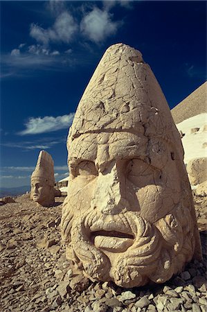 Statue head portraying Zeus, and Antiochos in background, on the west terrace at Nemrut Dag, UNESCO World Heritage Site, Anatolia, Turkey, Asia Minor, Eurasia Stock Photo - Rights-Managed, Code: 841-02944654