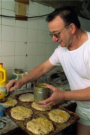 Man making Pain des Mortes, Boulangerie Faby, Bonifacio, Corsica, France, Europe Fotografie stock - Rights-Managed, Codice: 841-02944665
