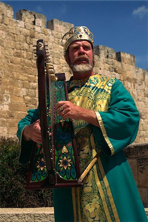 Portrait of a man with harp wearing traditional clothes singing in front of the city walls of Jerusalem, Israel, Middle East Stock Photo - Rights-Managed, Code: 841-02945726