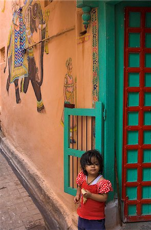 Small girl standing in doorway of typical house decorated with Mewar folk art, Jagdish Mandir area, old city, Udaipur, Rajasthan state, India, Asia Stock Photo - Rights-Managed, Code: 841-02945834