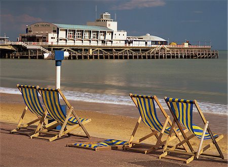 shopping malls in england - Deckchairs on the Promenade overlooking the deserted beach and Pier Theatre early in the summer season, West Cliff, Bournemouth, Dorset, England, United Kingdom, Europe Stock Photo - Rights-Managed, Code: 841-02946155