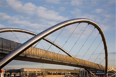 The new Celtic Gateway Bridge for pedestrians and cyclists, part of Holyhead Forward regeneration project, ferry terminal beyond, Porth Celtaidd, Holyhead, Anglesey, Wales, United Kingdom, Europe Stock Photo - Rights-Managed, Code: 841-02946275