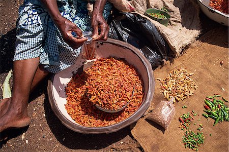Woman sorting chili peppers (chillies) in a metal bowl, Ghana, West Africa, Africa Stock Photo - Rights-Managed, Code: 841-02947167