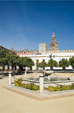 real alcazar - Plaza just outside the exit to the Real Alcazar with La Giralda in background, Santa Cruz district, Seville, Andalusia (Andalucia), Spain, Europe Stock Photo - Rights-Managed, Code: 841-02994222