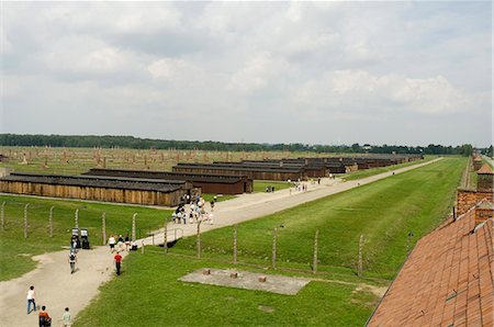 Wooden sheds, formerly stables for horses, that each held 500 prisoners, many now demolished, but chimneys still stand in the background, Auschwitz second concentration camp at Birkenau, UNESCO World Heritage Site, near Krakow (Cracow), Poland, Europe Stock Photo - Rights-Managed, Code: 841-02992890
