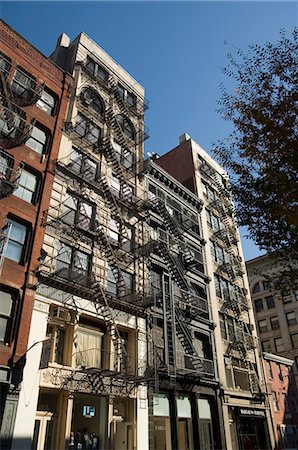 soho, new york - Fire escapes on the outside of buildings in Spring Street, Soho, Manhattan, New York City, New York, United States of America, North America Fotografie stock - Rights-Managed, Codice: 841-02993139