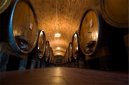 Wine casks in the wine cellars of the Villa Vignamaggio, a wine producer whose wines were the first to be called Chianti, near Greve, Chianti, Tuscany, Italy, Europe Stock Photo - Rights-Managed, Code: 841-03027950