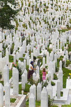 Muslim woman and child tend a grave at a war cemetery, Sarajevo, Bosnia, Bosnia-Herzegovina, Europe Stock Photo - Rights-Managed, Code: 841-03028873