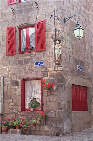 Statue der Madonna und des Kindes auf ein Haus mit roten Fensterläden an einer Straßenecke in Besse En Chandesse, in der Auvergne, Frankreich, Europa Stockbilder - Lizenzpflichtiges, Bildnummer: 841-03030145