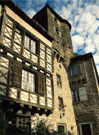 Exterior of stone house with wooden windows and turret in the village of Segur le Chateau, Correze, Limousin, France, Europe Stock Photo - Rights-Managed, Code: 841-03030559