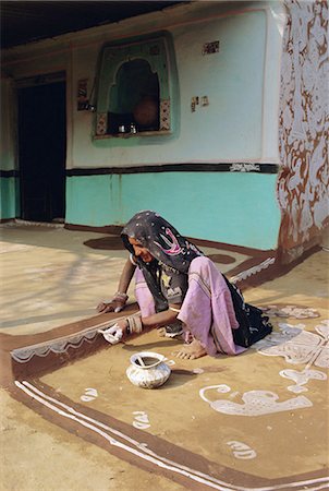 Woman painting the wall of a village house, Tonk region, Rajasthan, India Stock Photo - Rights-Managed, Code: 841-03032855