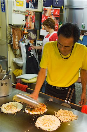 Okonomiyaki Japanese pancake being made at Fast Food Outlet at Okonomimura, Hiroshima City, Hiroshima prefecture, Honshu Island, Japan, Asia Stock Photo - Rights-Managed, Code: 841-03055627