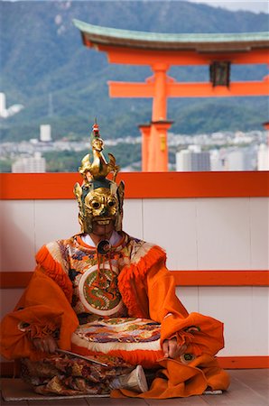 A Wedding Ceremony Dance Performer in front of the Floating Torii Gate at Itsukushima Shrine, founded in 593, UNESCO World Heritage Site, Miyajima Island, Hiroshima prefecture, Honshu Island, Japan, Asia Stock Photo - Rights-Managed, Code: 841-03055633