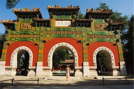 Chinese girl under a glazed archway at the Confucius Temple Imperial College built in 1306 by the grandson of Kublai Khan administering the official Confucian examination system, Beijing, China, Asia Stock Photo - Rights-Managed, Code: 841-03055670